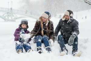 family sitting in the snow